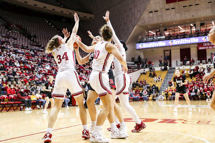 Grace Berger, Aleksa Gulbe and Kiandra Browne triple team a Nebraska player.